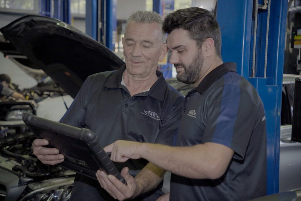 Nestocar owners – father and son – running a factory-level diagnostic scan on a European car in East Brisbane